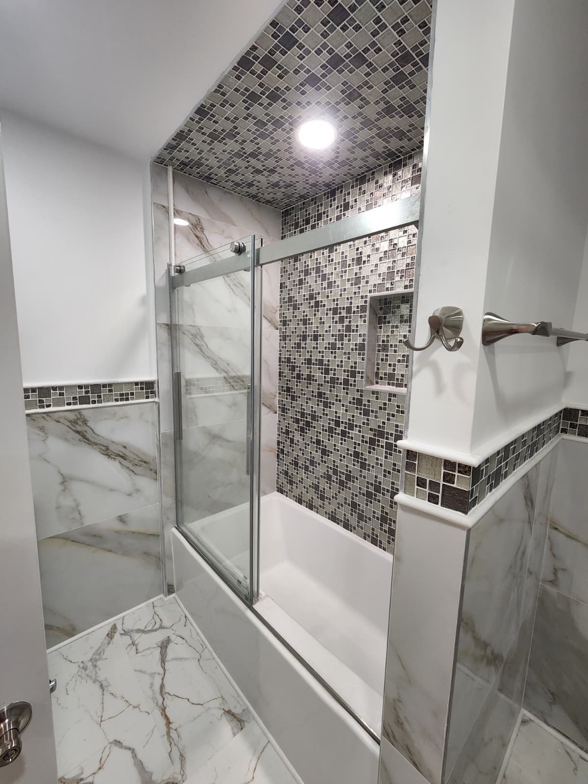 Remodeled bathroom with large-format porcelain tile floor
