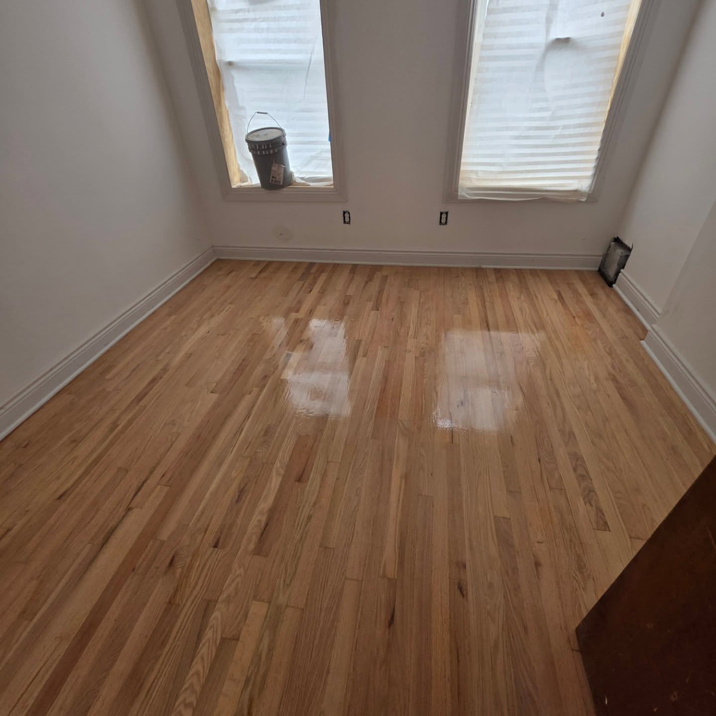 Craftsman sanding a hardwood floor with a drum sander